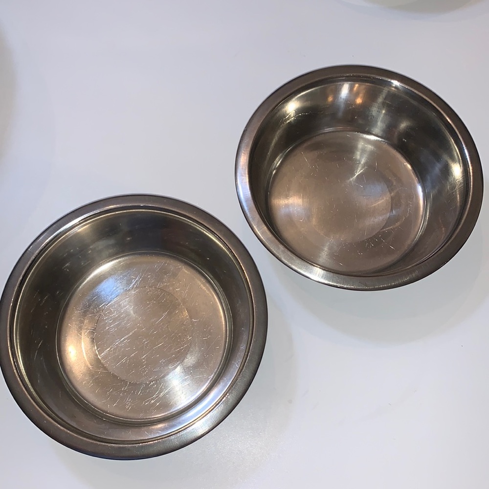 Two stainless steel dog bowls 8 inches across 2 1/2 inches high